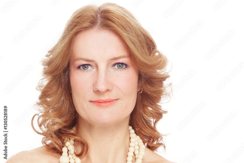 Portrait of beautiful healthy happy smiling mature woman with curly hair and clean make-up over white background
