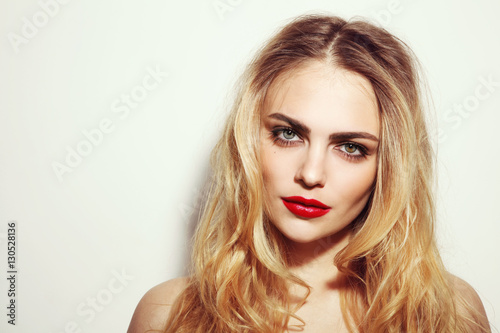 Vintage style portrait of young beautiful girl with long messy hair and red lips