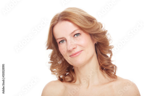 Portrait of beautiful healthy happy smiling mature woman with curly hair and clean make-up  over white background