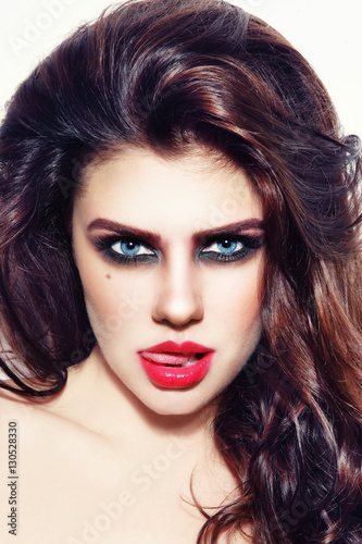 Portrait of young beautiful sexy teasing woman with stylish make-up and hairdo