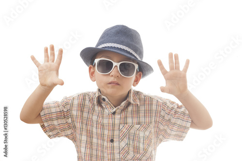 Caucasian kid with hat and sunglasses. Isolated on white background. Space for copy or other design.Showing his hands. © vlasc
