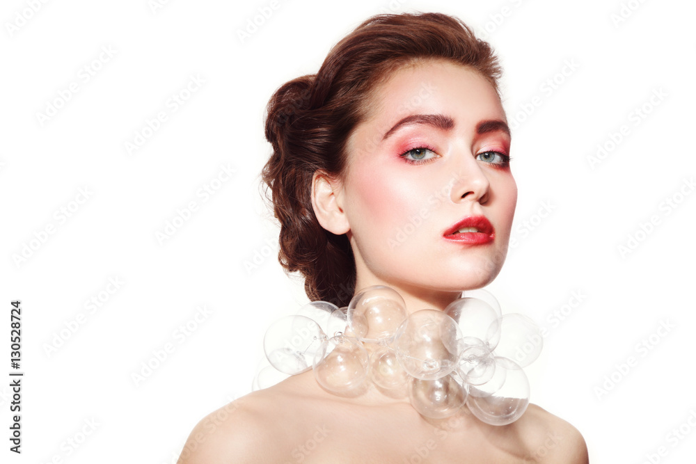 Portrait of young beautiful woman with stylish rose make-up and fancy bubble-glass necklace