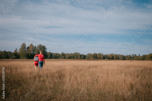 the loving couple walks on the wheat field