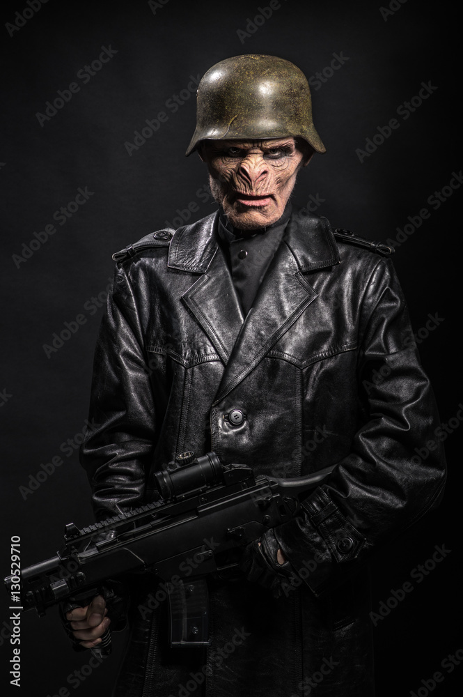 Angry baboonish man in black clothes on dark background Angry baboonish man in black clothes on dark background