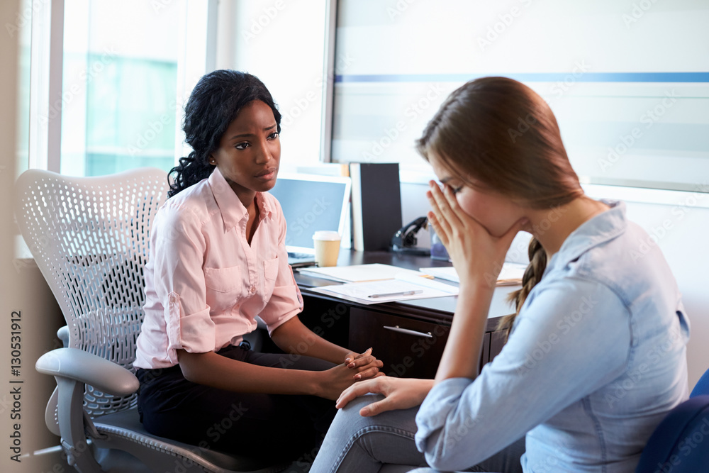 Fototapeta premium Doctor In Consultation With Depressed Female Patient