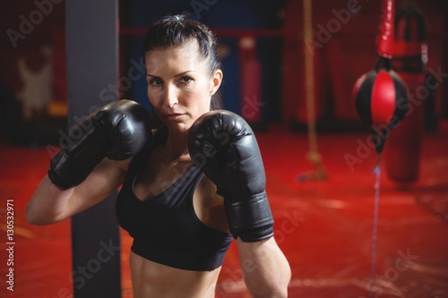 Confident female boxer performing boxing stance