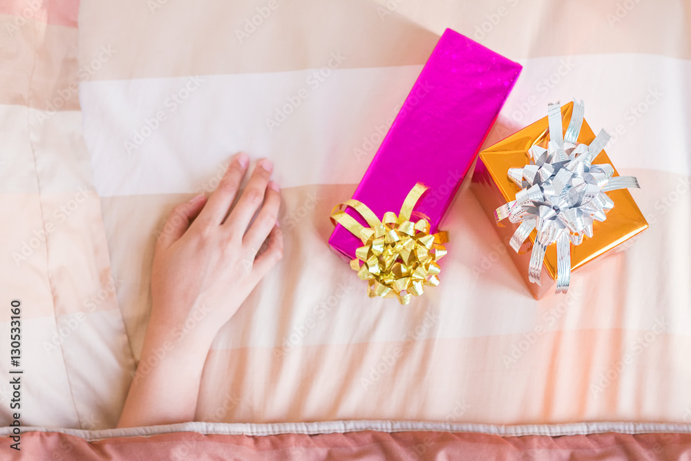 Woman hand under blanket with Christmas gifts, Boxing day concep Woman hand under blanket with Christmas gifts, Boxing day concep