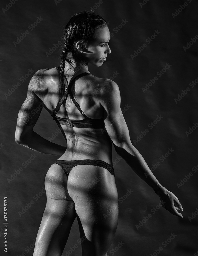 Fototapeta premium Fitness Model on black background 