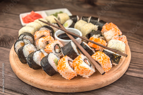 Sushi Set sashimi and  rolls on a wooden board.  background