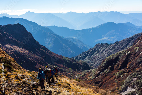 Group of People with Backpacks walking on Trail on Himalaya Trek © alexbrylovhk