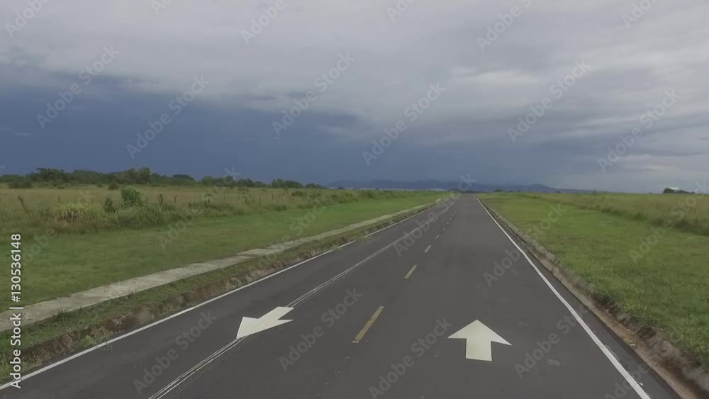 Aerial view of camera moving forward above a lonely two way road Aerial view of camera moving forward above a lonely two way road
