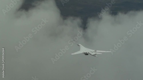 Military plane flying through the clouds