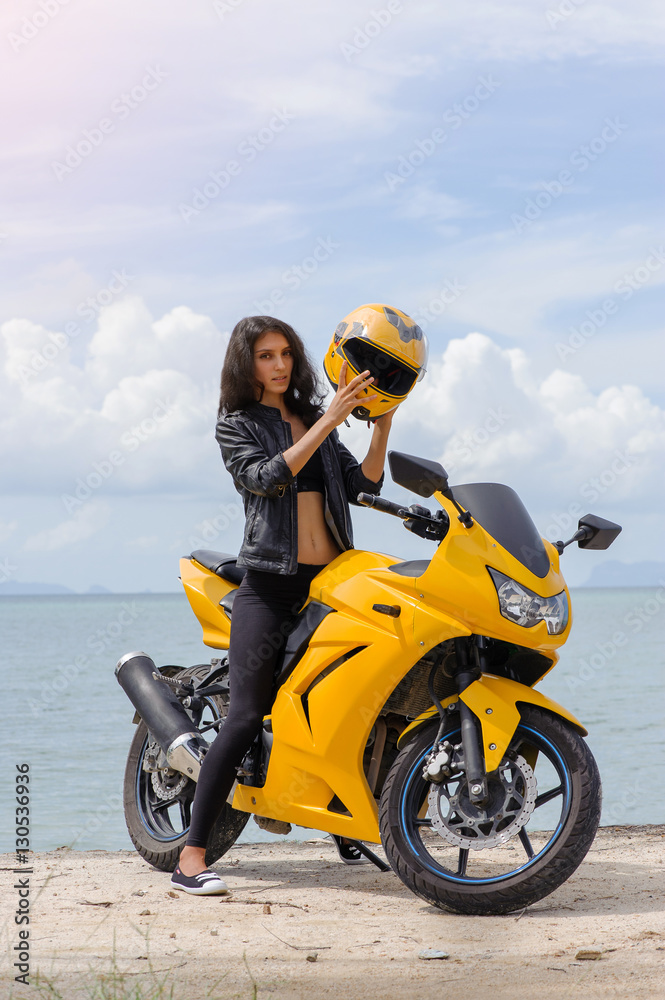 Attractive lady on yellow sport motorcycle