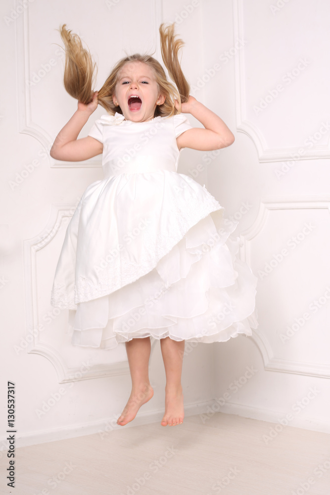 Screaming girl jumping and holding her hair. White background Screaming girl jumping and holding her hair. White background