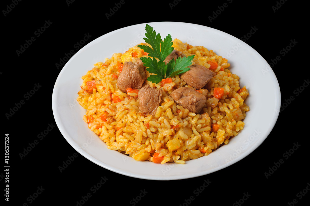 Fragrant pilaf with meat and vegetables top view on a plate. Fragrant pilaf with meat and vegetables top view on a plate.