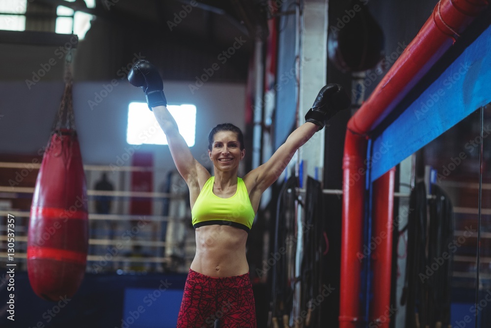 Excited female boxer posing after victory