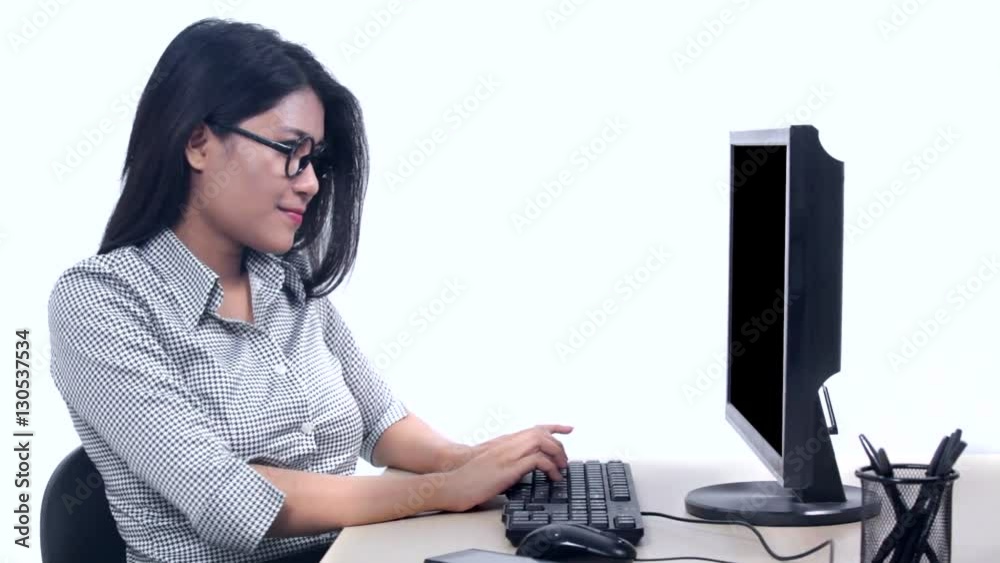 Young Asian businesswoman working with a computer and expressing her success, isolated on white background Young Asian businesswoman working with a computer and expressing her success, isolated on white background