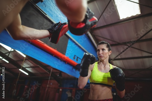 Boxers using focus mitts during training © WavebreakMediaMicro