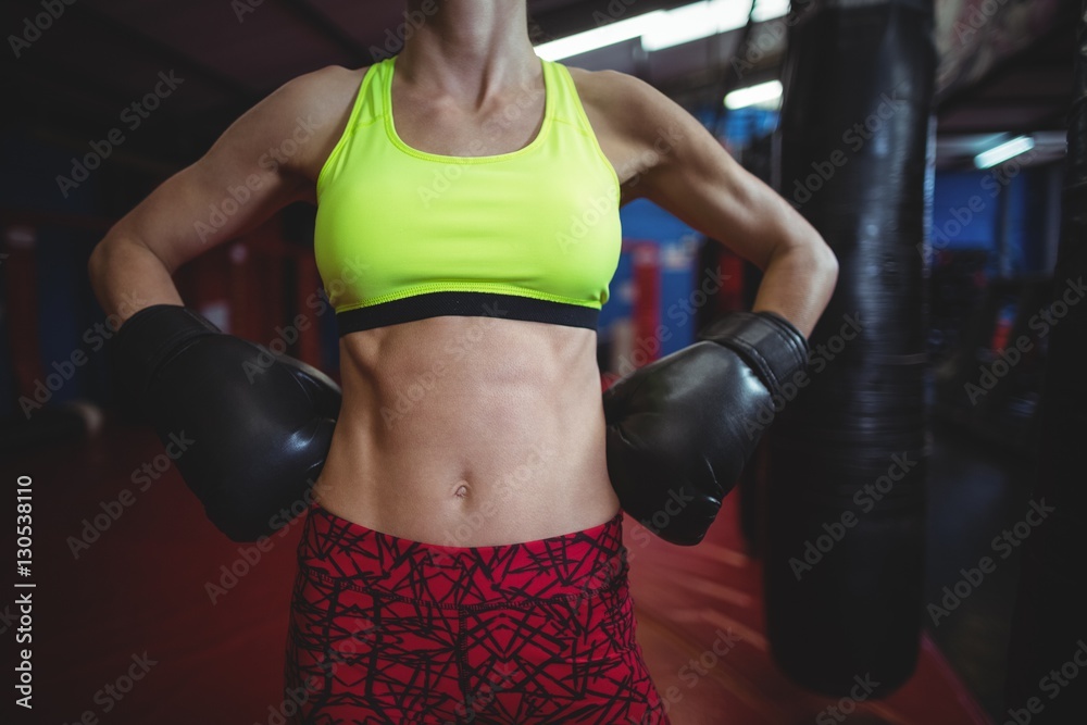 Female boxer standing with hands on hip