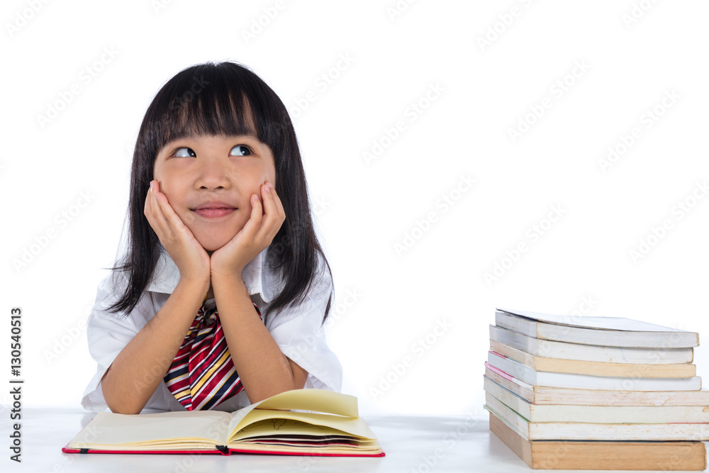 Asian Chinese little girl thinking while reading Asian Chinese little girl thinking while reading
