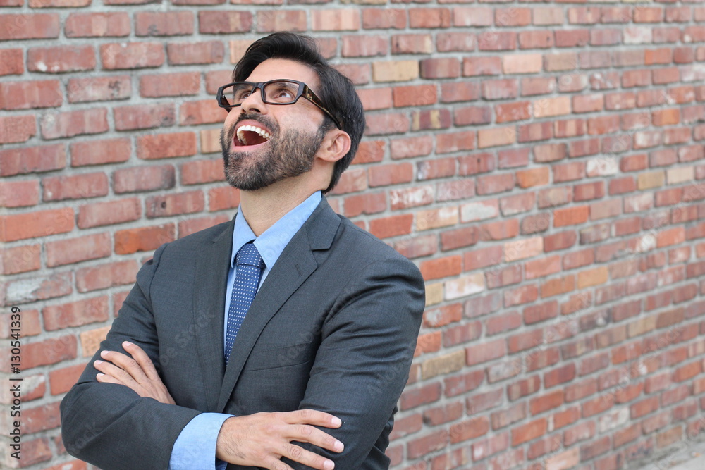 Hilarious businessman looking up with his mouth wide open 