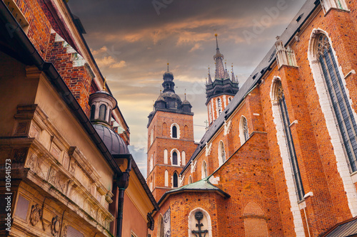 Church of St. Mary in the main Market Square on the background of dramatic sky. Basilica Mariacka. Krakow. Poland. photo