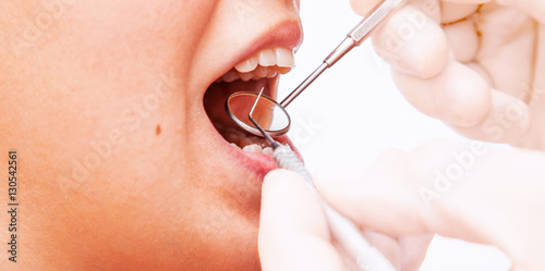 Doctor doing dental treatment to his patient in clinic. photo