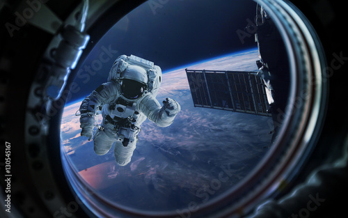 Naklejka Planeta Ziemia i astronauta w iluminatorze statku kosmicznego. Elementy tego zdjęcia dostarczone przez NASA