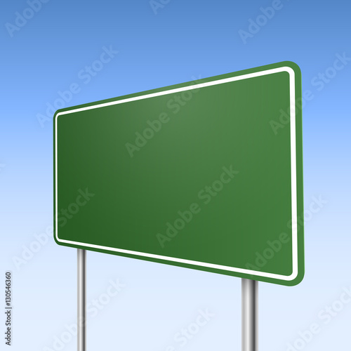 Big green direction road sign with blue sky background.
