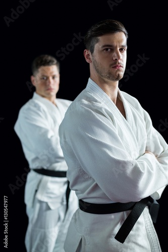 Karate players standing with arms crossed