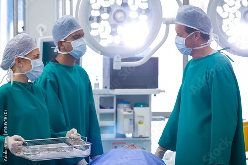 Surgeons interacting while performing operation 