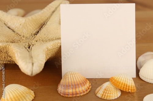 note paper encircled by shells and sea star