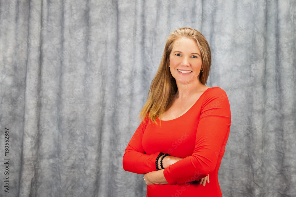 Fototapeta premium Blonde Female In Red Dress with Arms Folded 