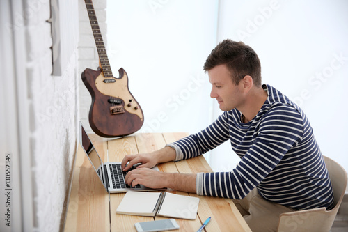 Young composer sitting at a...