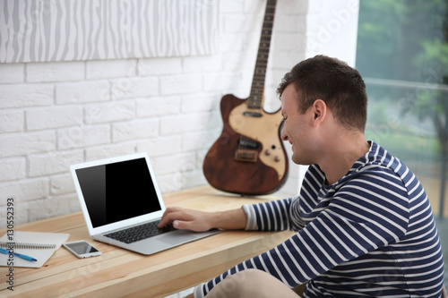 Young composer sitting at a...