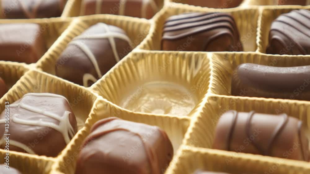 Female picking one of many different candies background 4K 2160p 30fps UltraHD footage - Making choice from assorted chocolate gift box 3840X2160 UHD video 