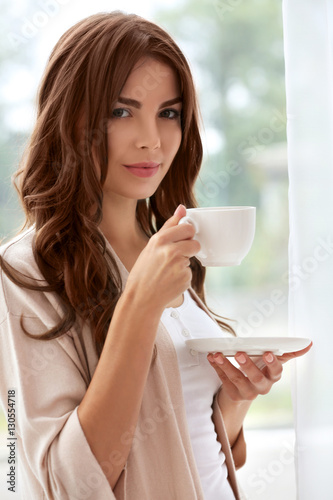 Beautiful woman with cup of...