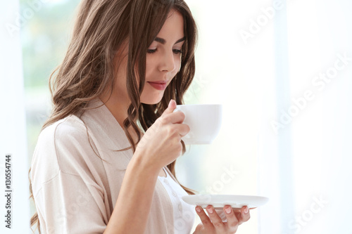 Beautiful woman with cup of...