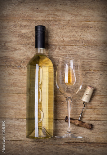 Bottle of wine with glass and corkscrew