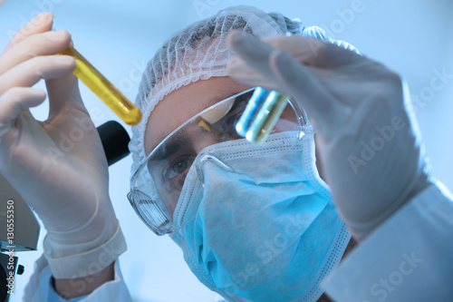 Young male scientist making...