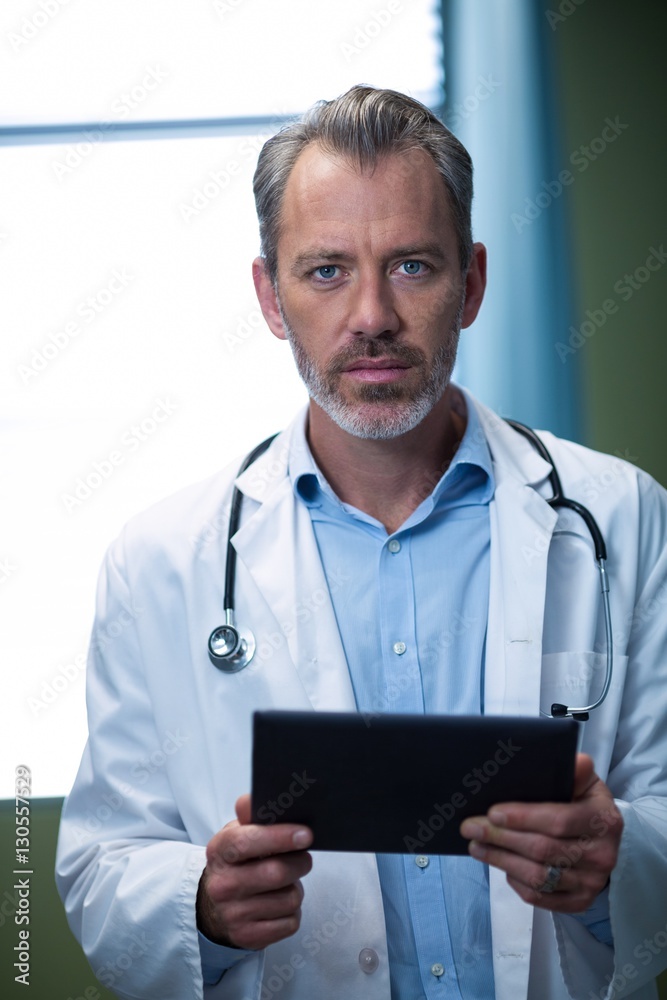 Portrait of doctor using digital tablet in ward Portrait of doctor using digital tablet in ward