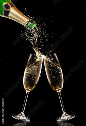 Two glasses of champagne with bottle over black background
