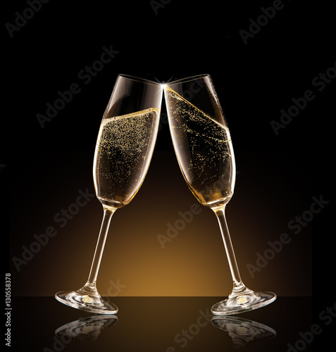 Two glasses of champagne over black background