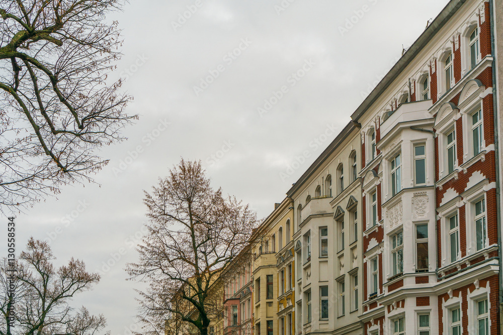 beautiful apartment houses in a autumn street with trees