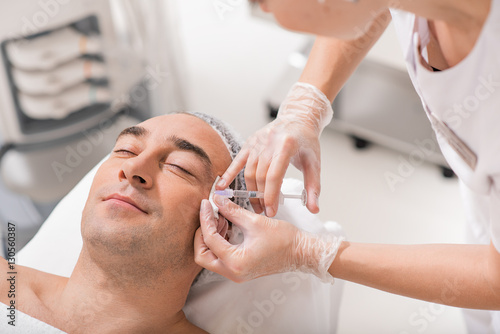Calm male patient having plastic procedure