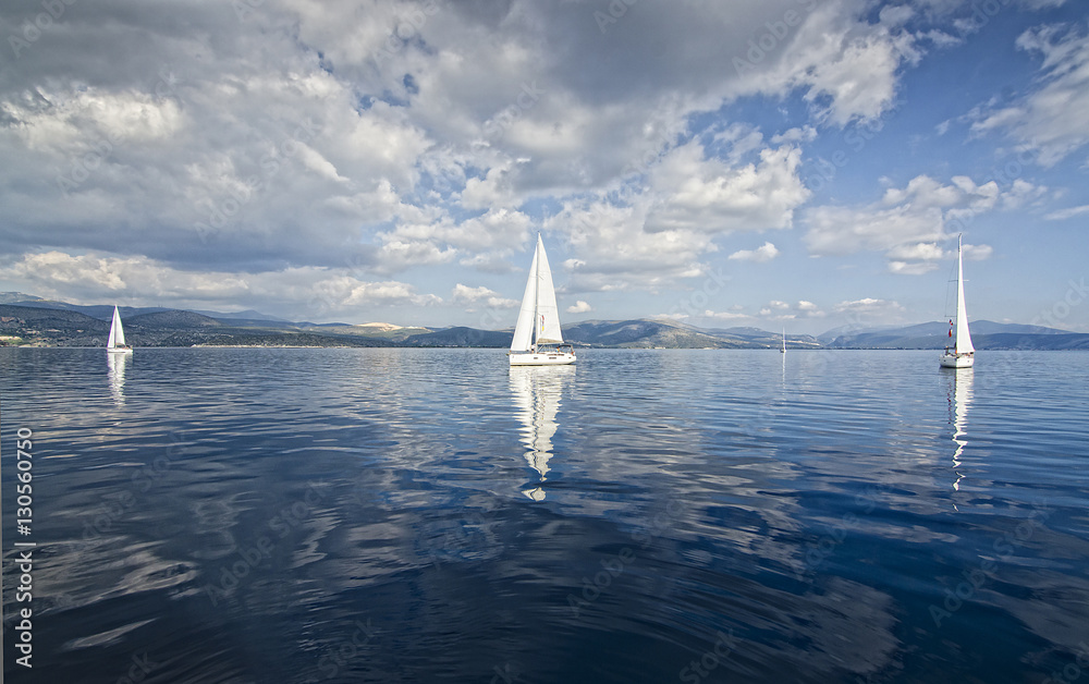 Obraz premium Sun Rays/Race in the calm during the regatta in the mediterranean
