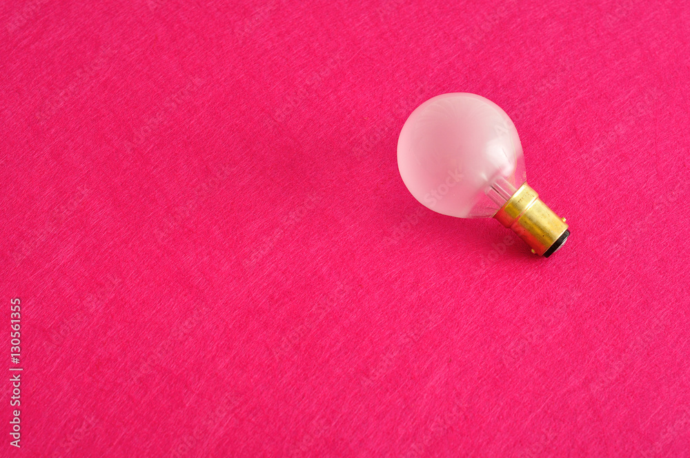 A light bulb isolated on a pink background A light bulb isolated on a pink background