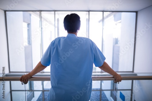 Fototapeta Naklejka Na Ścianę i Meble -  Rear view of female nurse standing in corridor