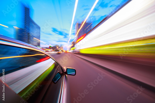 The car moves at fast speed at the night. Blured road with lights with car on high speed.