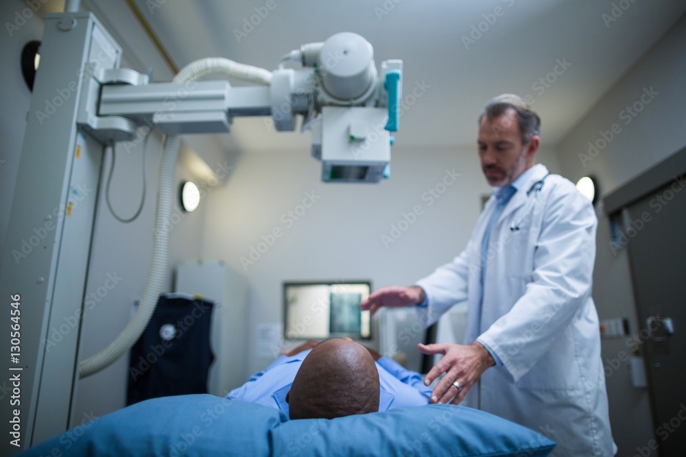Male doctor taking an x-ray of patient Male doctor taking an x-ray of patient